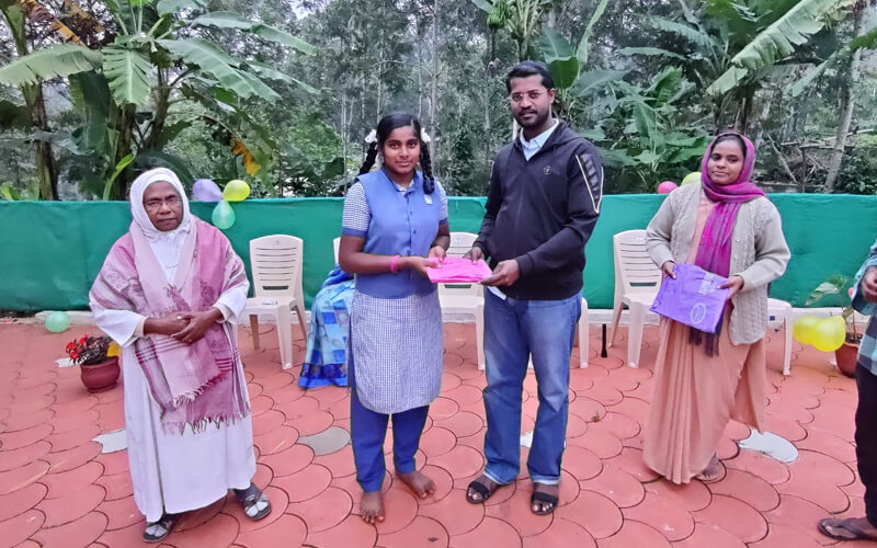 Fr. John Wilson Gifting Rain Coats to the Vasambadi Night School Children