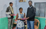 Fr. John Wilson Presenting Rain Coat to M.G.R Nagar Night School Children