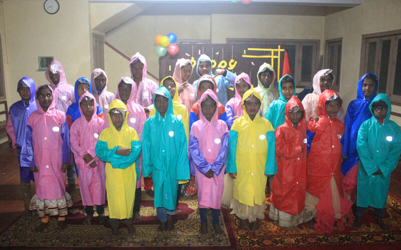 Happy Faces of Kovilmedu Children with Colourful Rain Coats