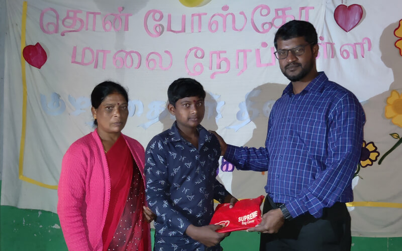 Murugan Nagar Night School Children Receiving Gift from Fr. John Wilson